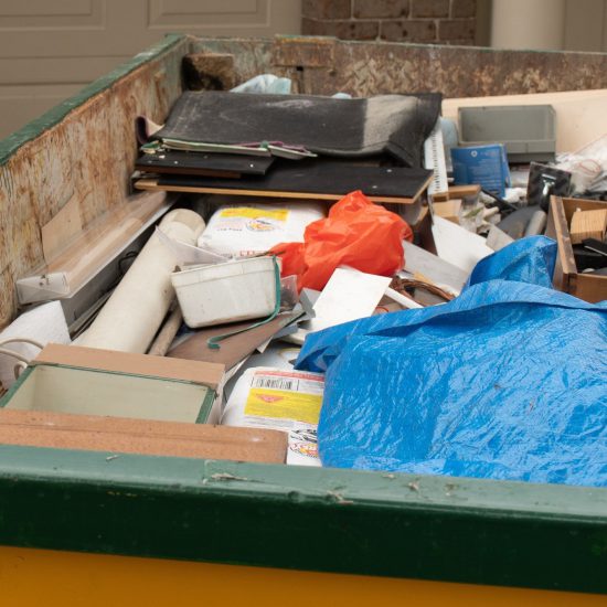skip-bin-full-of-household-waste-rubbish-on-the-front-yard-house-clean-up.jpg