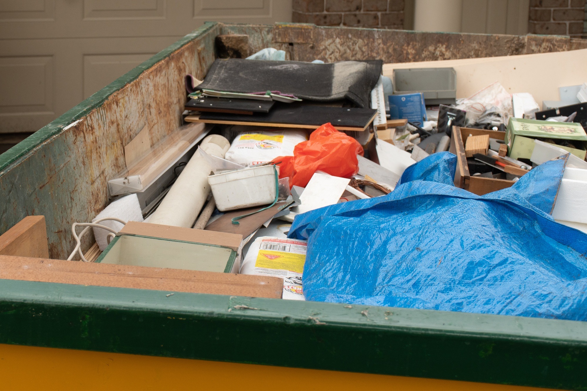 skip-bin-full-of-household-waste-rubbish-on-the-front-yard-house-clean-up.jpg